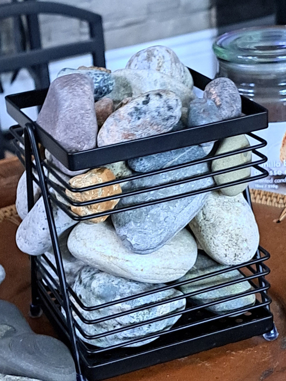 Black Metal Decorative Basket Filled with Smooth River Rocks